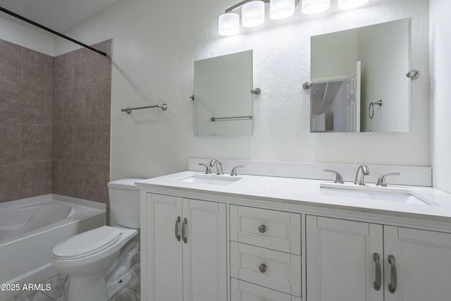 full bathroom with toilet, tiled shower / bath, and vanity