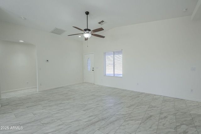 empty room with ceiling fan and lofted ceiling