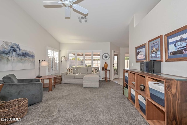 carpeted living room featuring high vaulted ceiling and ceiling fan