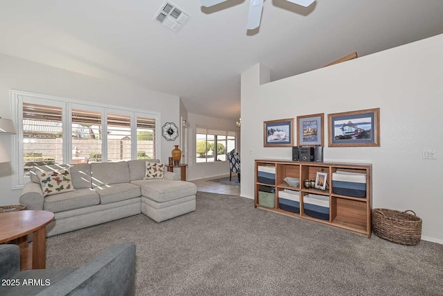 living room with ceiling fan, lofted ceiling, and carpet