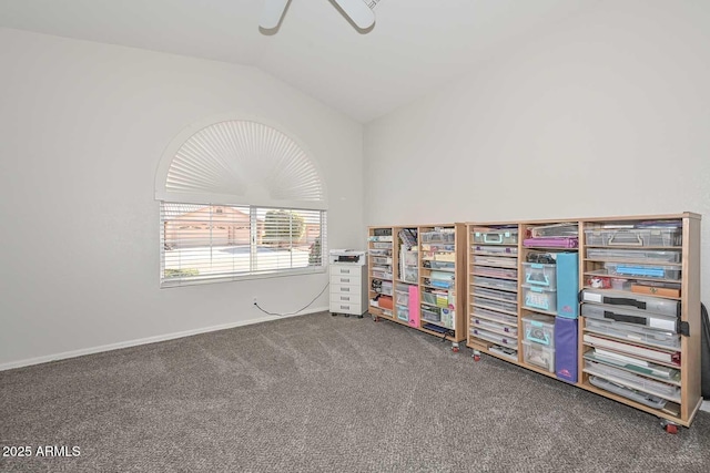 interior space featuring ceiling fan, vaulted ceiling, and carpet