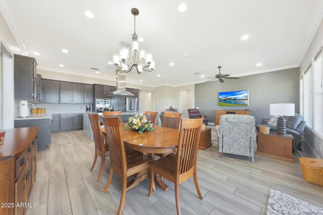 13236 W Montansoro Ln, Peoria, AZ 85383 - dining room with a chandelier, light wood-style floors, recessed lighting, ceiling fan, and crown molding
