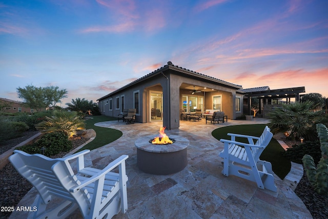 13236 W Montansoro Ln, Peoria, AZ 85383 - rear view of house featuring a patio area, a pergola, ceiling fan, stucco siding, and an outdoor living space with a fire pit