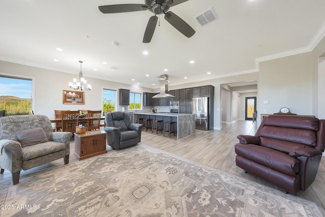 13236 W Montansoro Ln, Peoria, AZ 85383 - living area featuring recessed lighting, a chandelier, light wood finished floors, ornamental molding, and a ceiling fan