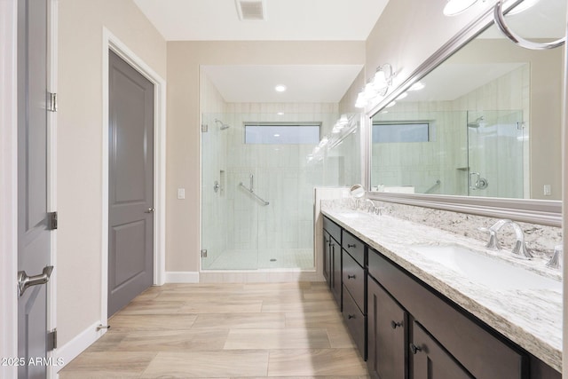 13236 W Montansoro Ln, Peoria, AZ 85383 - full bathroom with a stall shower, double vanity, and baseboards