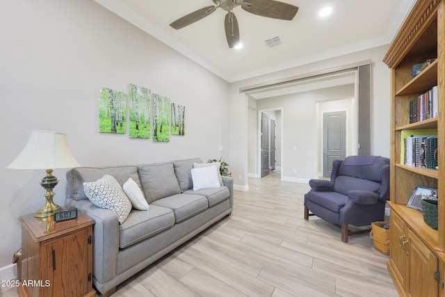 13236 W Montansoro Ln, Peoria, AZ 85383 - living room featuring a ceiling fan, crown molding, baseboards, and light wood finished floors