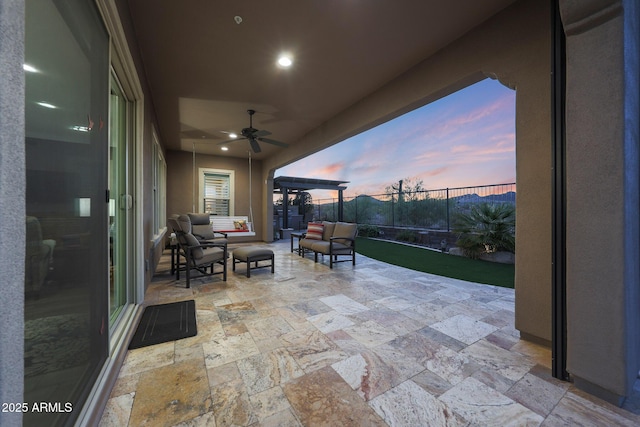 13236 W Montansoro Ln, Peoria, AZ 85383 - patio terrace at dusk featuring a patio area, a ceiling fan, and an outdoor living space