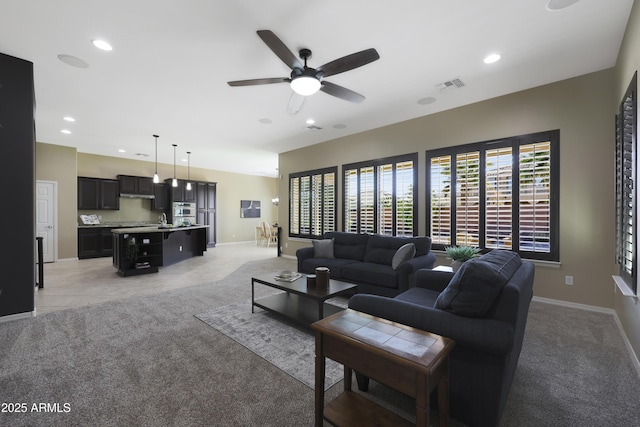 living room with light carpet, baseboards, visible vents, and recessed lighting