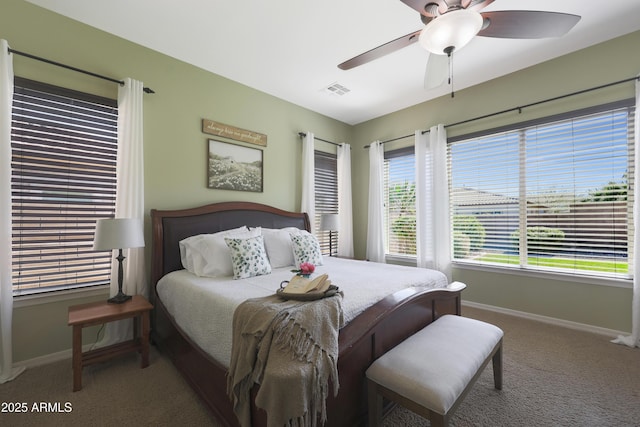 carpeted bedroom featuring ceiling fan, visible vents, and baseboards