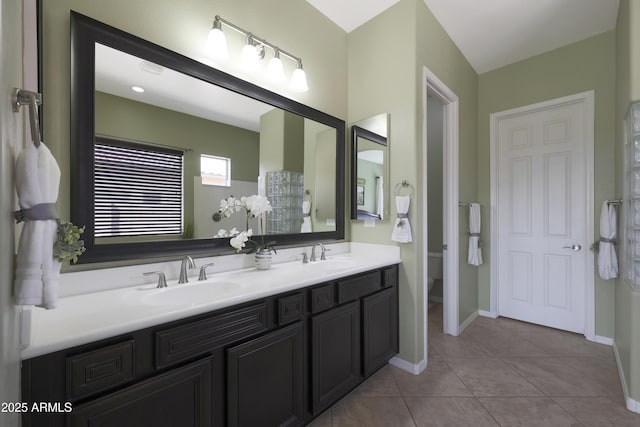 bathroom featuring double vanity, tile patterned flooring, a sink, and toilet