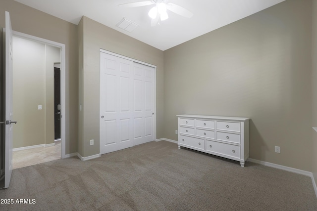 unfurnished bedroom with carpet, a closet, visible vents, and baseboards