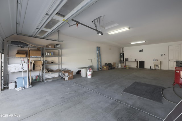 garage with water heater and a sink