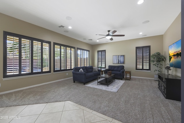 carpeted living room featuring baseboards, tile patterned flooring, visible vents, and recessed lighting