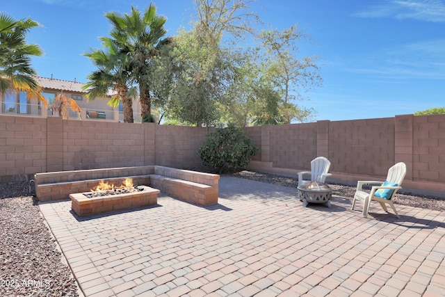 view of patio with an outdoor fire pit and a fenced backyard