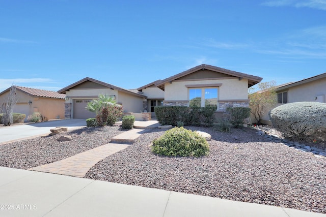 view of front of house with a garage, stone siding, concrete driveway, and stucco siding