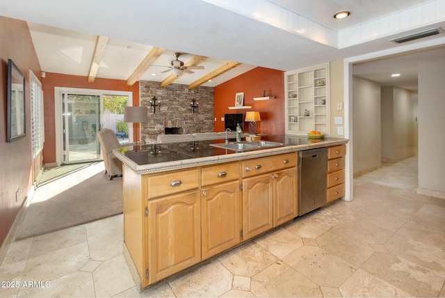 kitchen with ceiling fan, dishwasher, sink, beamed ceiling, and built in features