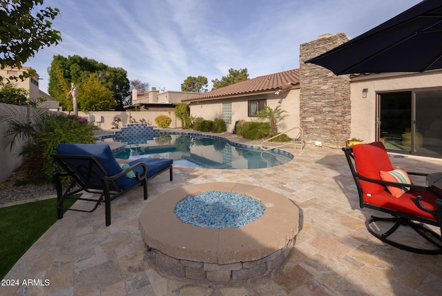 view of swimming pool with an outdoor fire pit and a patio