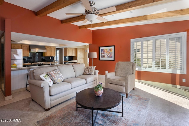 living room with ceiling fan, light colored carpet, and vaulted ceiling with beams