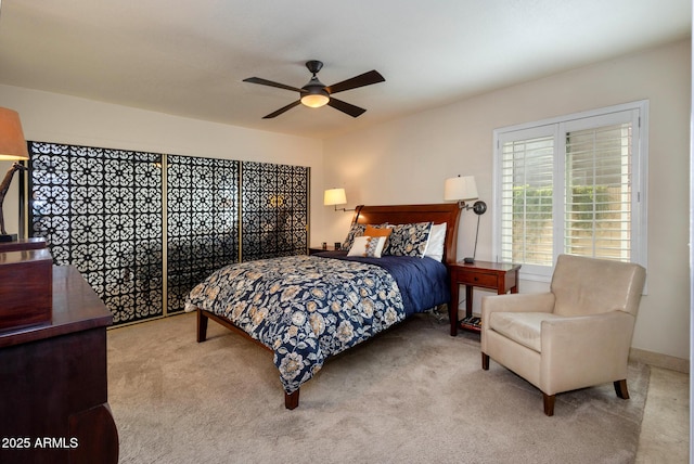 bedroom featuring ceiling fan and light carpet