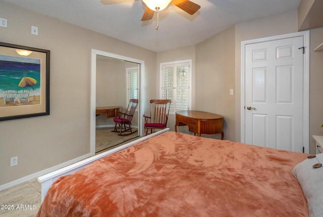 bedroom with ceiling fan and a closet