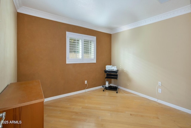 unfurnished room with ornamental molding and hardwood / wood-style flooring