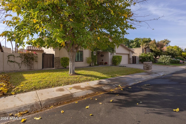 obstructed view of property with a front lawn and a garage