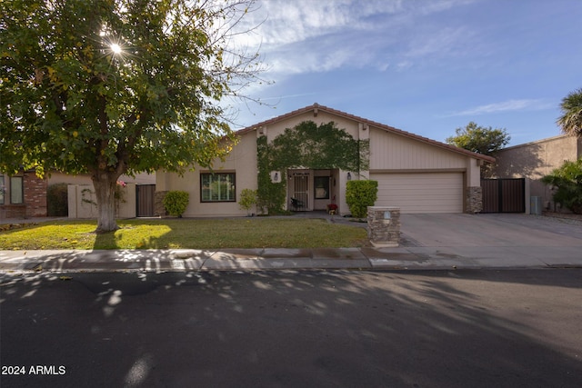 view of front of house with a garage and a front yard