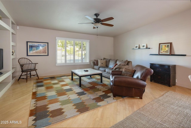 living room featuring ceiling fan and light hardwood / wood-style flooring