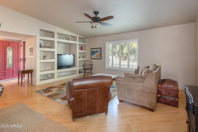 living room featuring ceiling fan, lofted ceiling, built in features, and light hardwood / wood-style floors