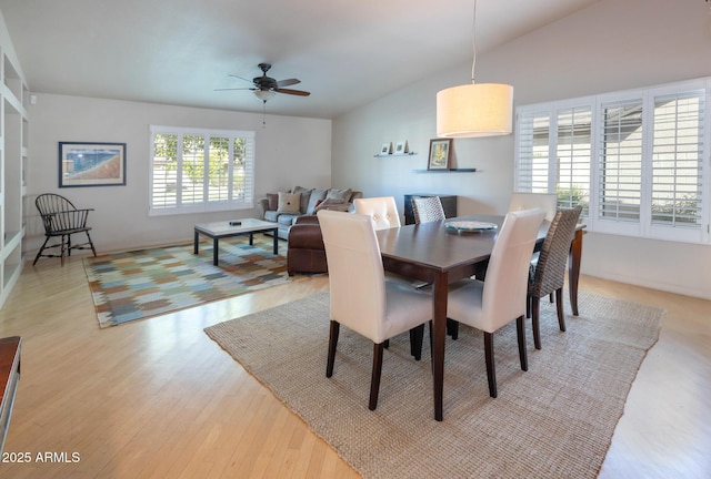 dining space featuring ceiling fan, light hardwood / wood-style flooring, and lofted ceiling