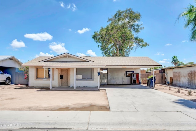 875 E Flint St, Chandler, AZ 85225 - view of front of home featuring an attached carport, concrete driveway, and stucco siding