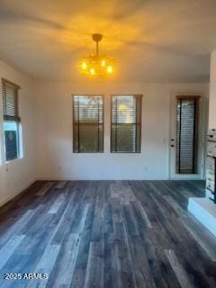 unfurnished living room with dark hardwood / wood-style flooring