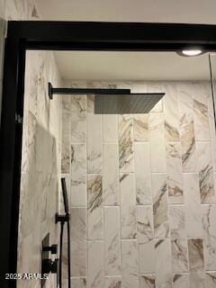 interior details with a tile shower