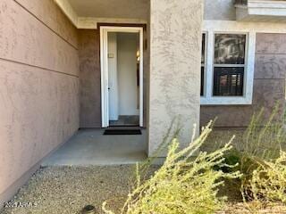 doorway to property featuring stucco siding