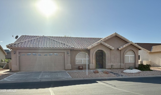 6942 S Championship Dr, Chandler, AZ 85249 - mediterranean / spanish home with concrete driveway, a garage, a tile roof, and stucco siding