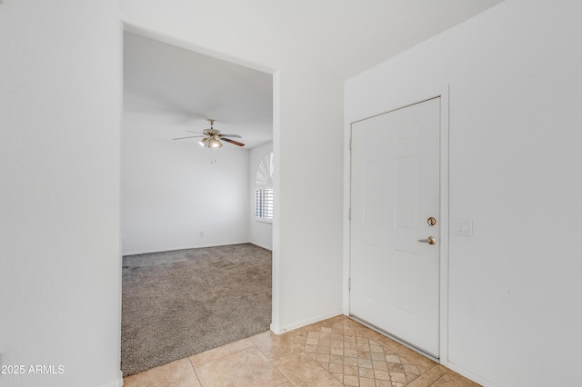 6942 S Championship Dr, Chandler, AZ 85249 - foyer entrance featuring ceiling fan, light colored carpet, light tile patterned floors, and baseboards