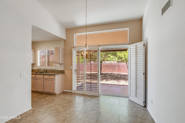 6942 S Championship Dr, Chandler, AZ 85249 - unfurnished dining area with a chandelier, a sink, healthy amount of natural light, and baseboards