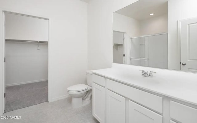 bathroom featuring vanity, toilet, tile patterned floors, and a shower with shower door