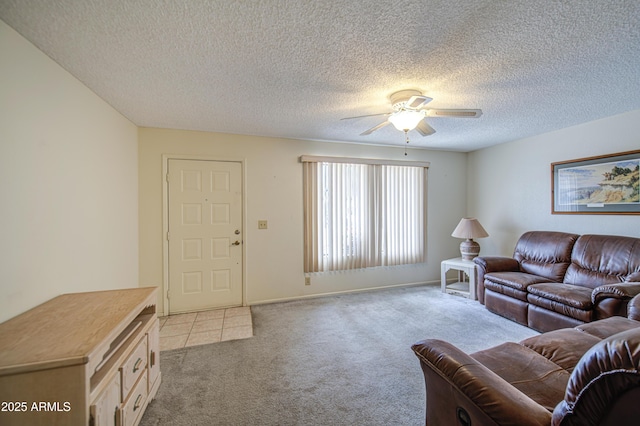 carpeted living room with a ceiling fan, a textured ceiling, and baseboards