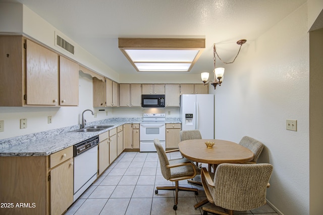 kitchen with white appliances, a sink, light countertops, a chandelier, and light brown cabinetry
