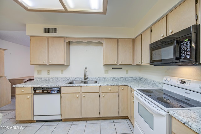 kitchen featuring white appliances, a sink, light brown cabinets, and light tile patterned floors