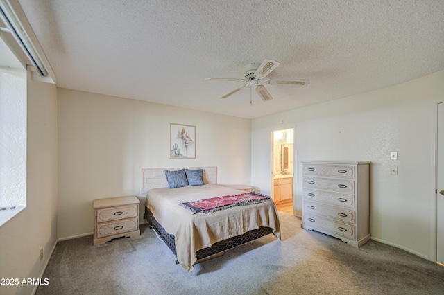 bedroom with light carpet, a textured ceiling, ceiling fan, baseboards, and ensuite bathroom