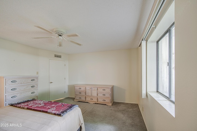 carpeted bedroom with multiple windows and a ceiling fan