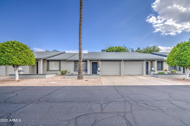 ranch-style home with a garage and concrete driveway
