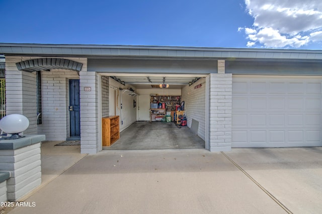 garage featuring concrete driveway