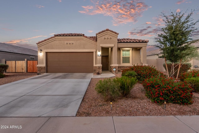 mediterranean / spanish-style home featuring a garage