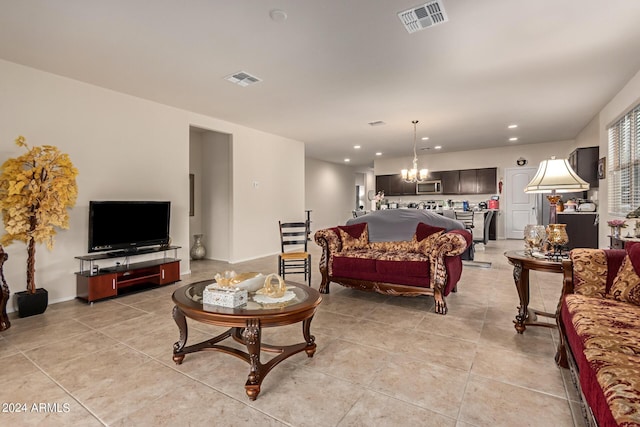 tiled living room with an inviting chandelier