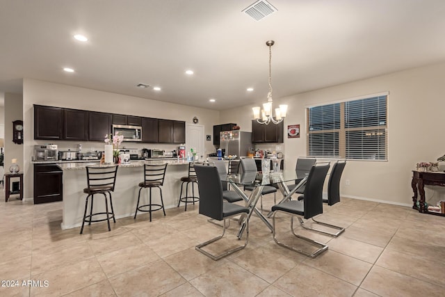 dining room with a chandelier and light tile patterned flooring