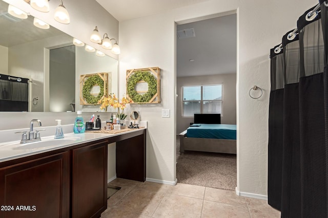 bathroom featuring tile patterned flooring and vanity