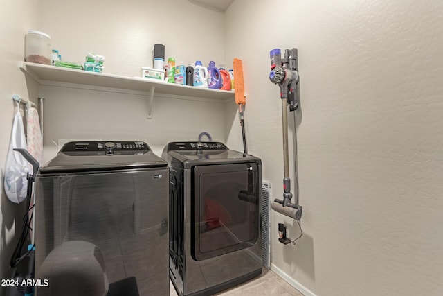 laundry area with light tile patterned floors and independent washer and dryer